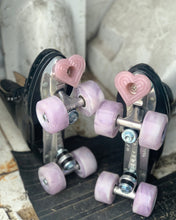 Load image into Gallery viewer, pair of black roller skates with light pink wheels and bbpink bolt-on heart shaped toe stops on a light gray and black background 