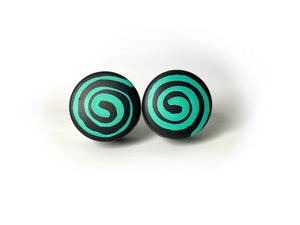 round roller skate toe stop in a black color with a teal swirl through it on a white background. 