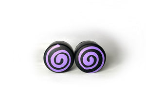 round roller skate toe stop in a black color with a purple swirl through it on a white background.