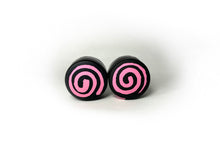 Load image into Gallery viewer, round roller skate toe stop in a black color with a pink swirl through it on a white background.