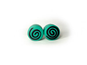 teal color round roller skate toe stop with a black swirl through it on a white background. .