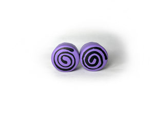 purple color round roller skate toe stop with a black swirl through it on a white background. 