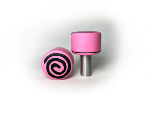 pink color round roller skate toe stop with a black swirl through it on a white background. 