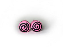 Load image into Gallery viewer, pink color round roller skate toe stop with a black swirl through it on a white background. 