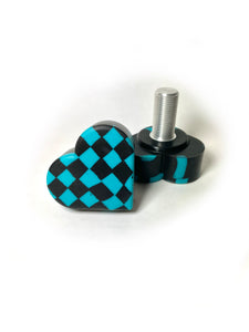 black and blue checker patterned heart shaped roller skate toe stop on a white background