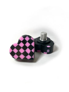 pink and black checker patterned heart shaped roller skate toe stop on a white background