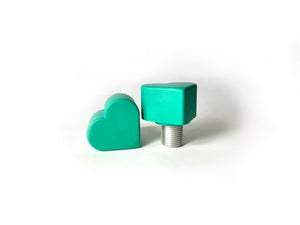 teal(turquoise) color heart shaped roller skate toe stop on a white background