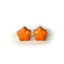 Load image into Gallery viewer, orange color roller skate toe stop in the shape of a five point star on a white background 