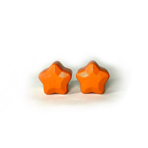 orange color roller skate toe stop in the shape of a five point star on a white background 